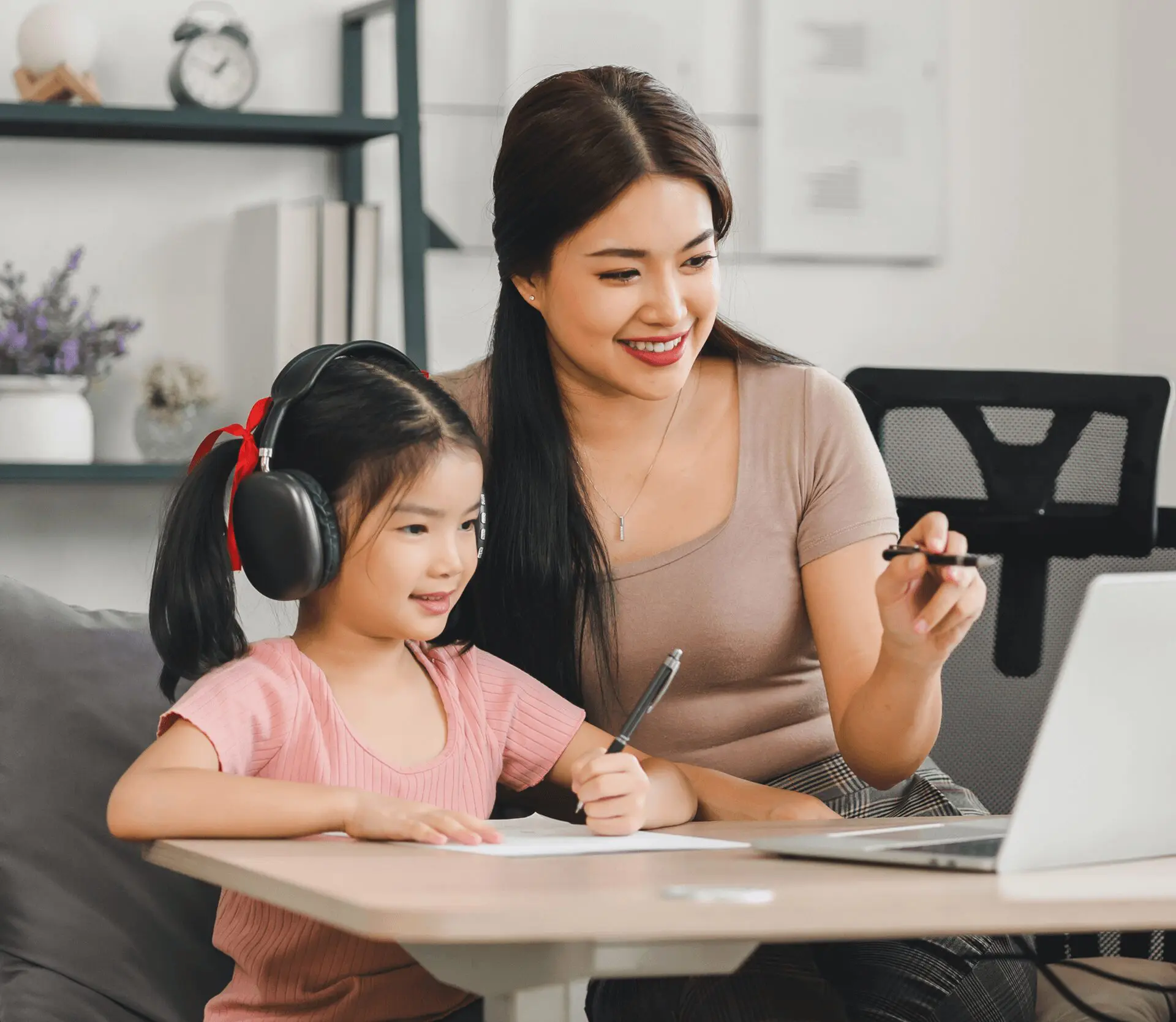 Mother and daughter learning together at laptop.